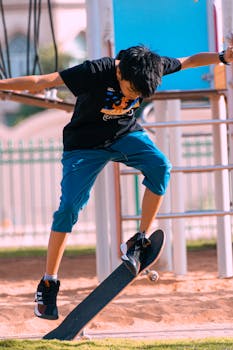 Teen boy performs a dynamic skateboarding trick outdoors, showcasing skill and energy.