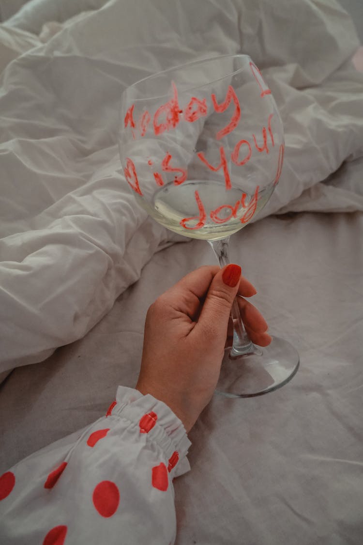 Woman Hand Holding Glass With Text