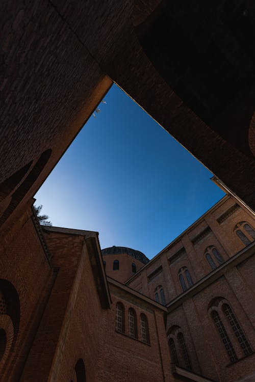 Low Angle Shot of an Old Brick Building Under Blue Sky