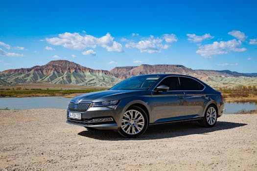 Stylish sedan parked against the stunning Nallıhan hills in Ankara, Türkiye, under a vibrant blue sky.