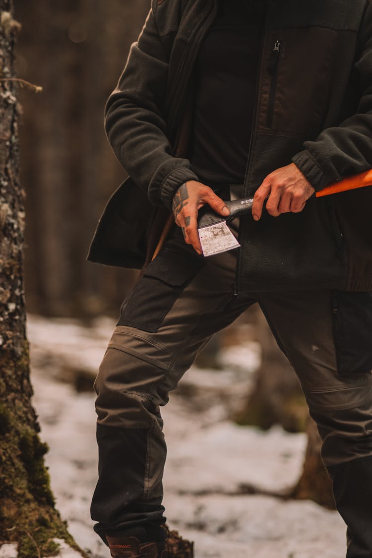 Man With An Axe In A Forest In Winter 