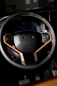 Close-up view of a luxury car's steering wheel highlighting its elegant design and high-quality materials.