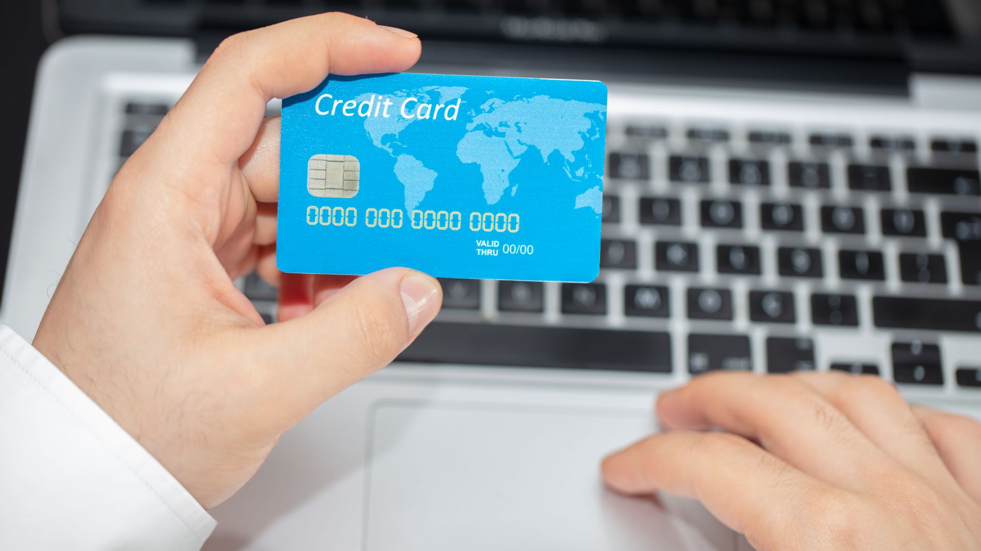 Buy Modafinil Online: A Complete Guide Person holding credit card near laptop for online shopping, emphasizing secure online transactions.