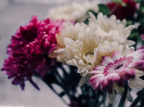 Close-up of a vibrant bouquet featuring chrysanthemums and gerberas in pink and white tones.