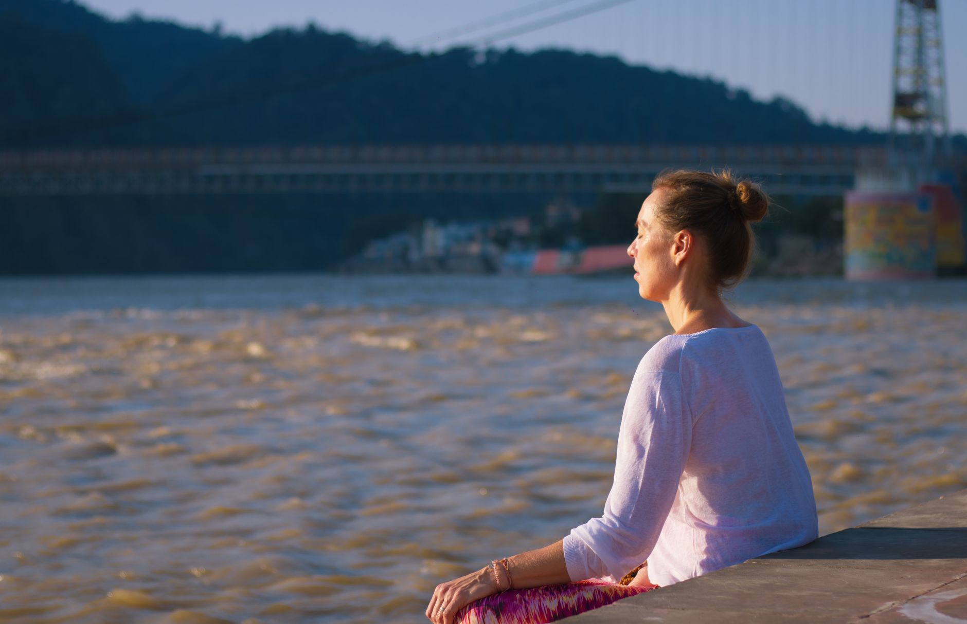 Woman relaxing in yoga pose in Rishikesh