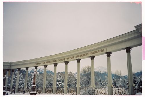 Free Snow-covered neoclassical colonnade with Cyrillic script in Almaty, Kazakhstan. Stock Photo