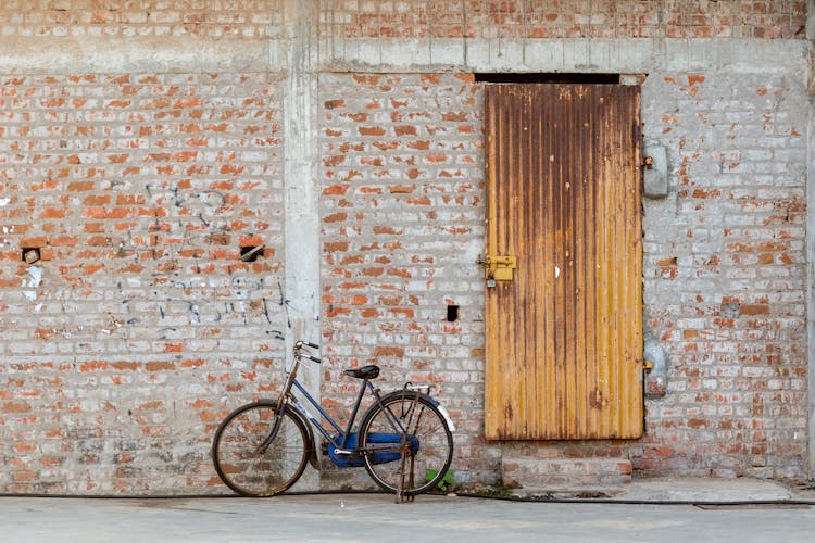 Bicycle Leaning Against A Building 