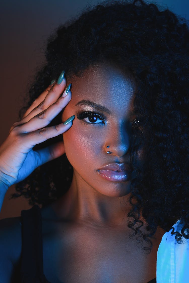 Studio Portrait Of A Young Woman In Split Blue Light