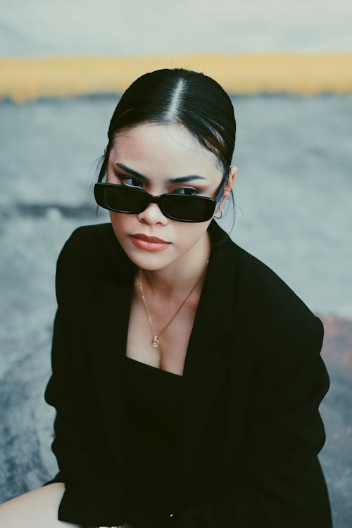 Young Woman in Black Clothing and Sunglasses