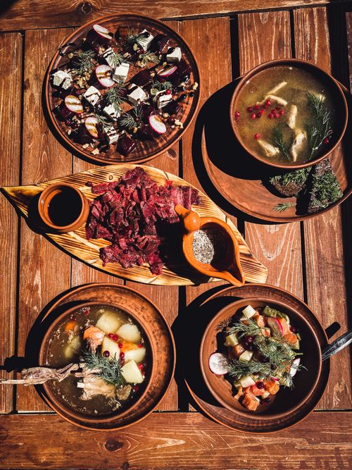 Free Delicious rustic Russian meal featuring traditional dishes served on wooden table. Captured in natural light. Stock Photo