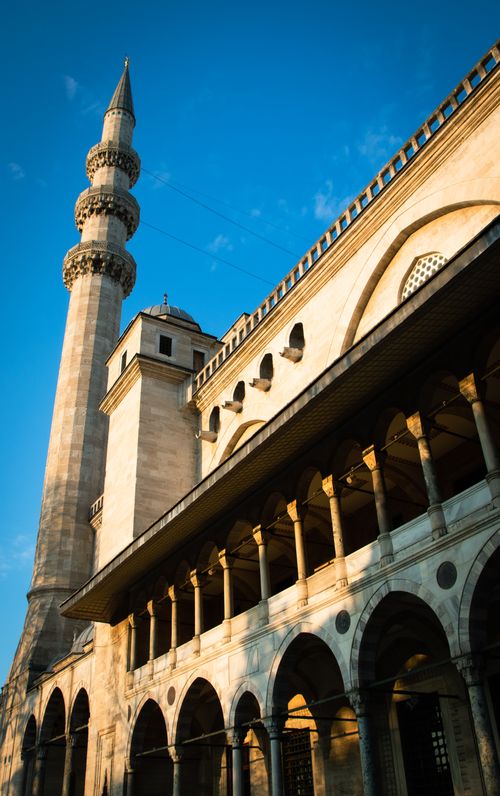 Free Elegant view of an Ottoman-era mosque with a striking minaret under clear blue skies. Stock Photo