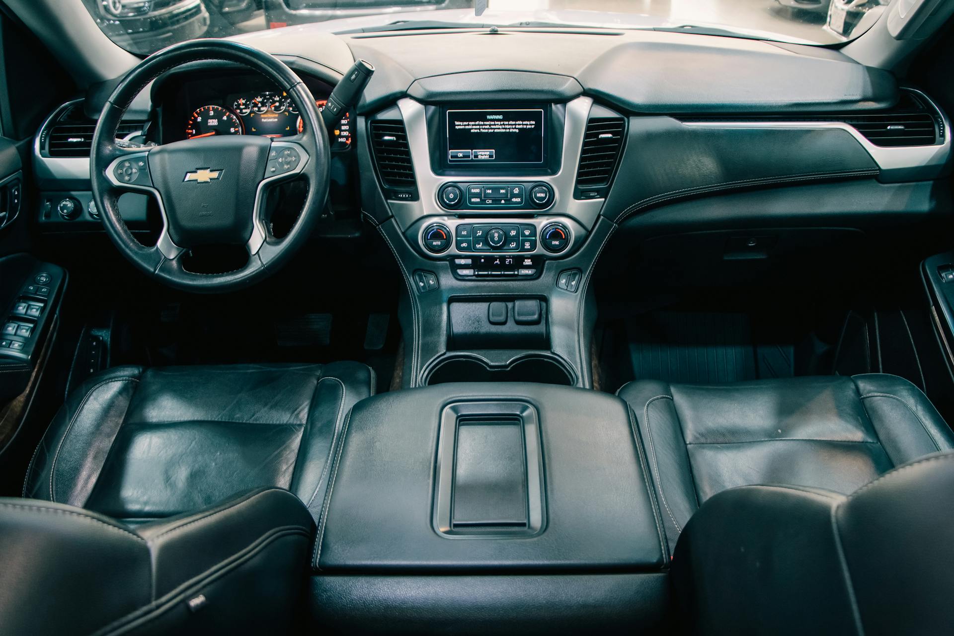 Explore the luxurious interior of a modern car featuring leather seats and a detailed dashboard.