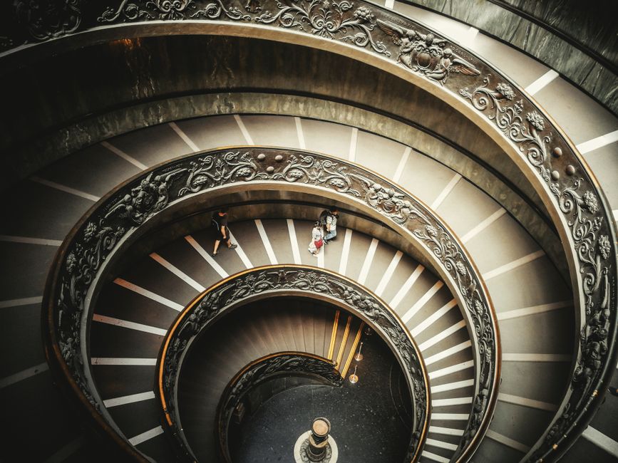 Captivating overhead view of an intricate spiral staircase with ornate design.