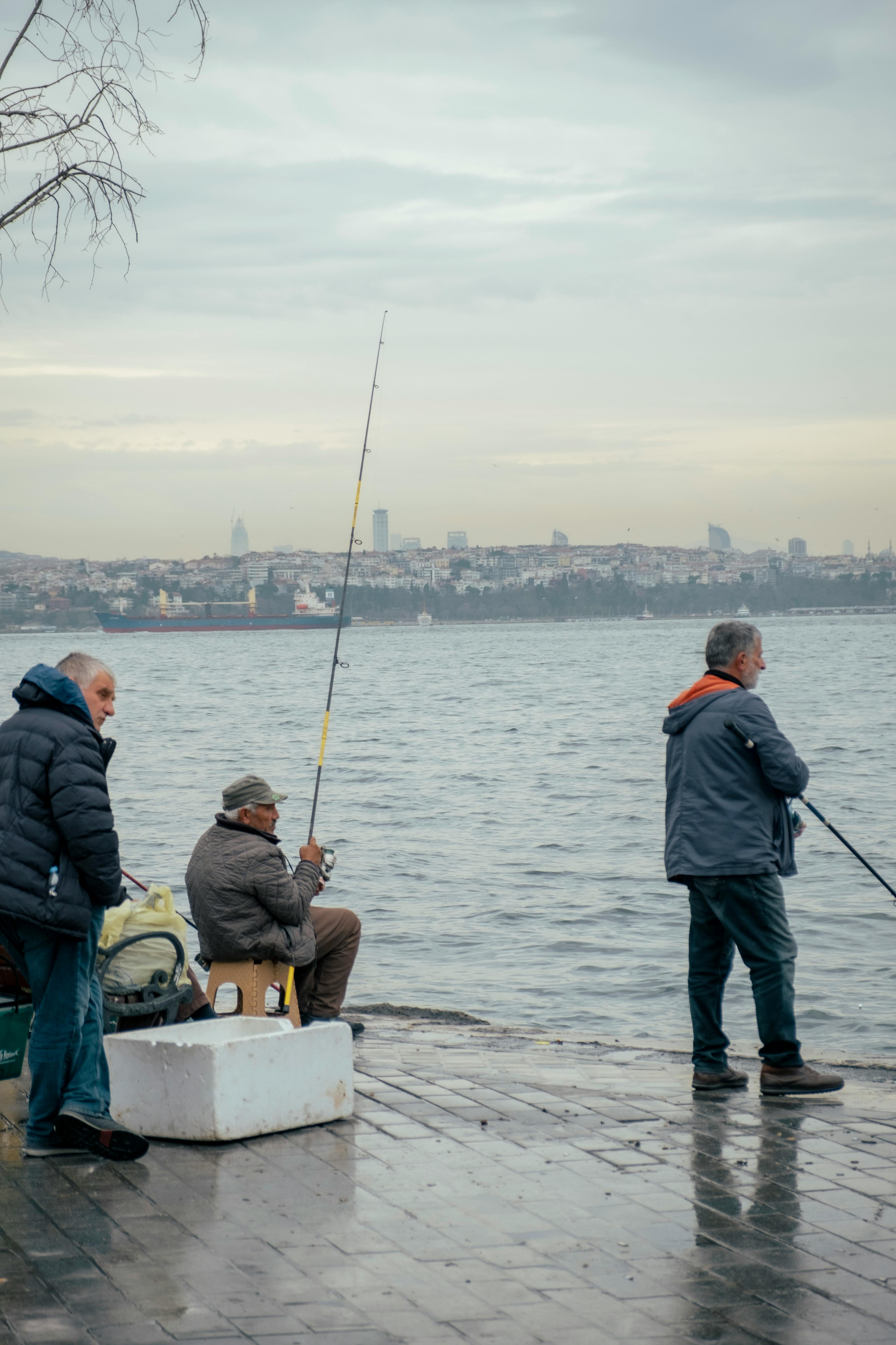 Premium Photo  Man holding a fishing rod standing on a bridge