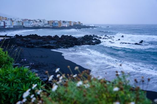 Free Explore the stunning black sand beach with rocky coastlines in Puerto de la Cruz, Tenerife, Spain. Stock Photo