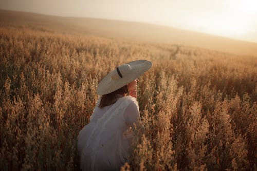 A Woman in a Field at Sunset