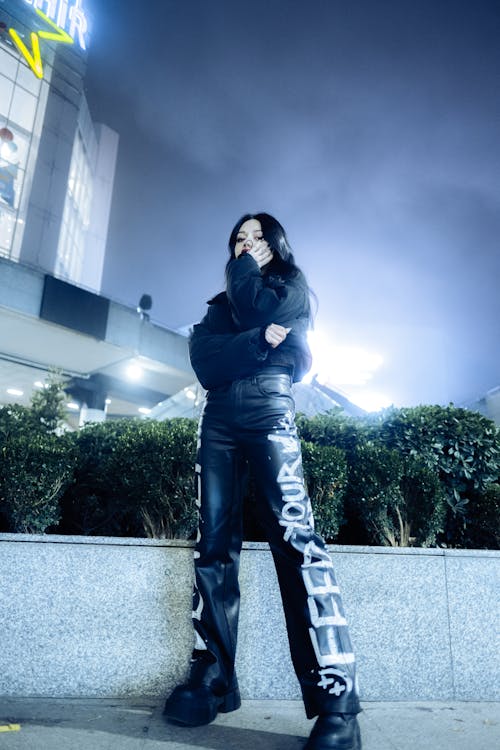 Young Woman in a Trendy Outfit in City at Night 