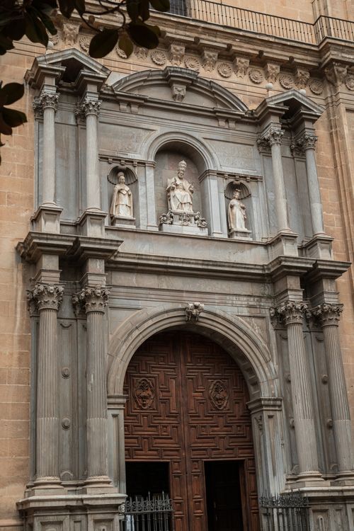 Free Detailed view of a beautifully sculpted church facade and entrance showcasing intricate architectural design. Stock Photo