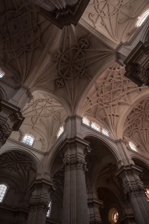 Free Intricate gothic ceiling and columns create a dramatic church interior scene. Stock Photo