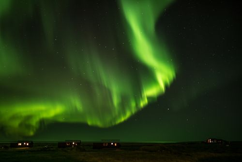 Free Stunning aurora borealis illuminating the night sky over Grindavík, Iceland. Stock Photo