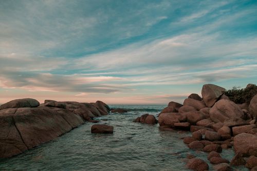 Free Rocky coastal scenery with dramatic clouds in Florianópolis, Brazil. Stock Photo