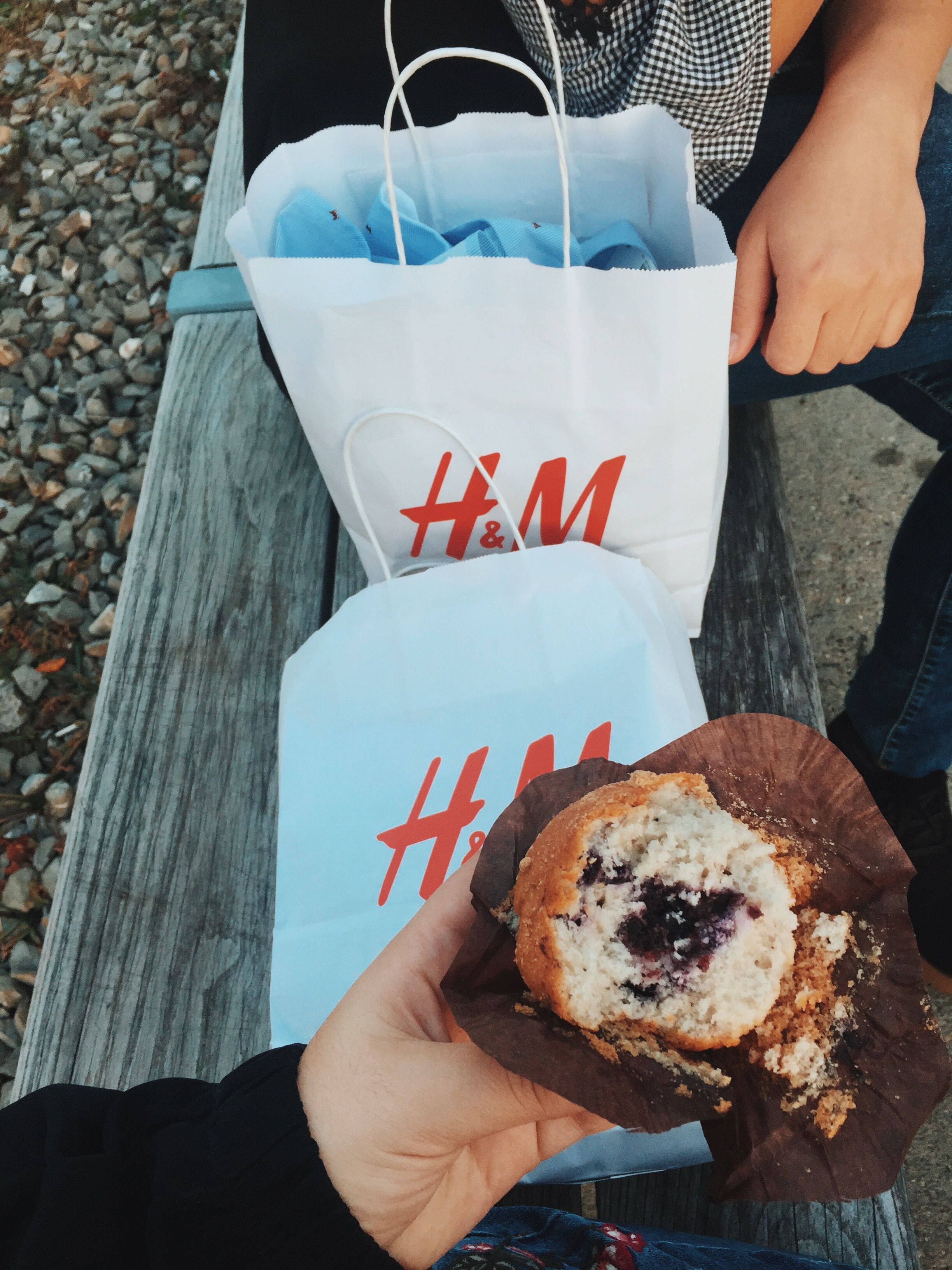 Enjoy a tasty blueberry muffin during a casual shopping day outdoors with friends.