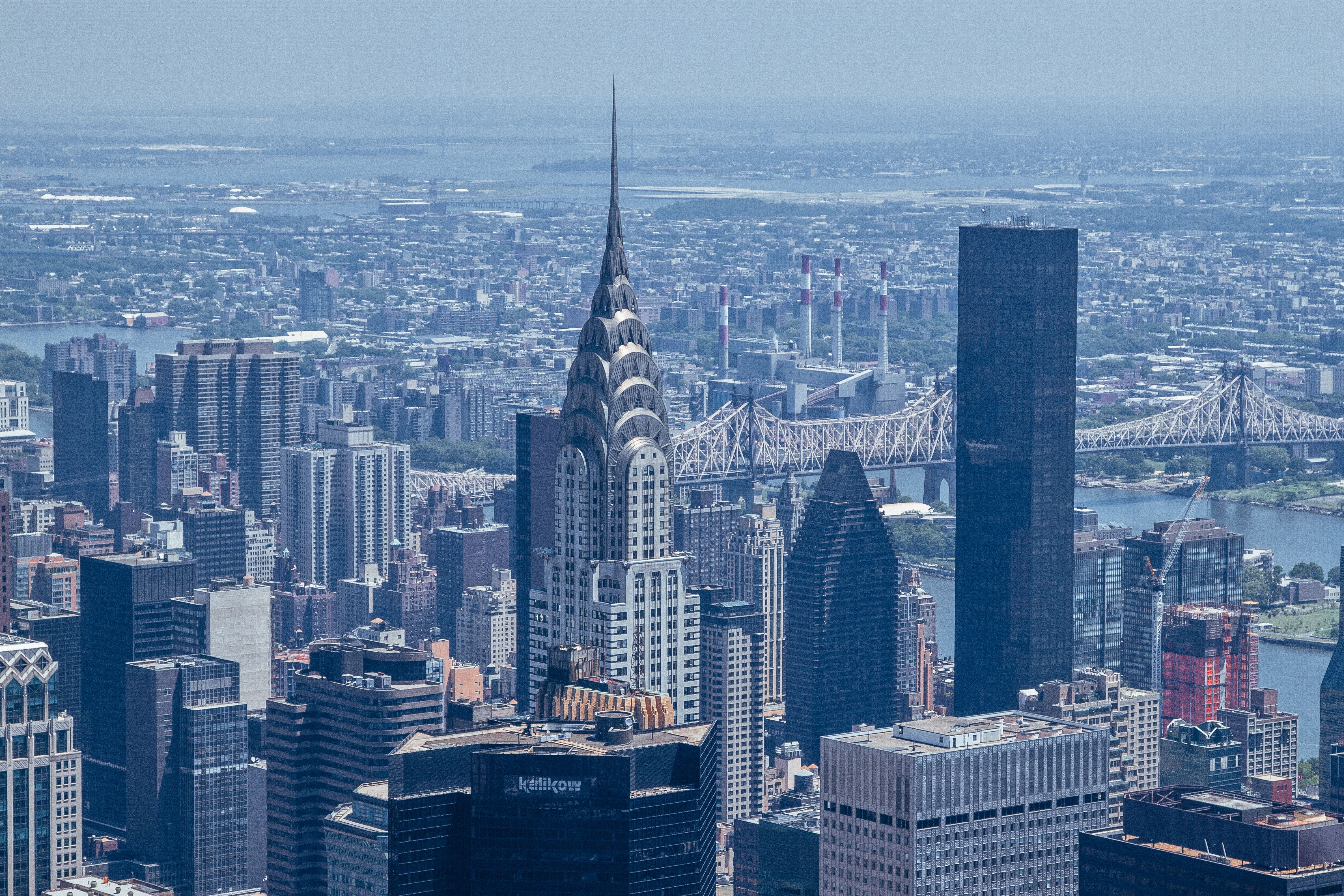 The Manhattan Helicopter Tour of New York - Stunning aerial view of New York City skyline showcasing the iconic Chrysler Building among other skyscrapers.