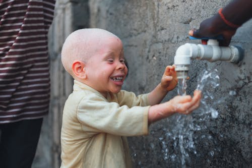 Smiling Boy Washing Hands