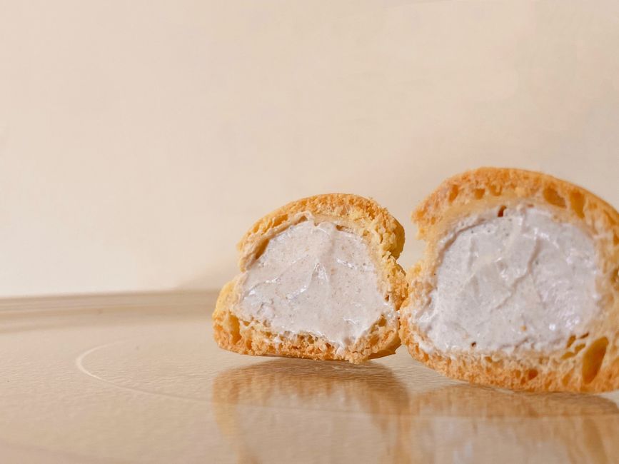 A close-up shot of cut profiteroles showing creamy filling, perfect for dessert lovers.