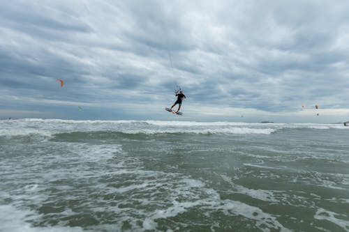 A Person Kiteboarding in the Sea