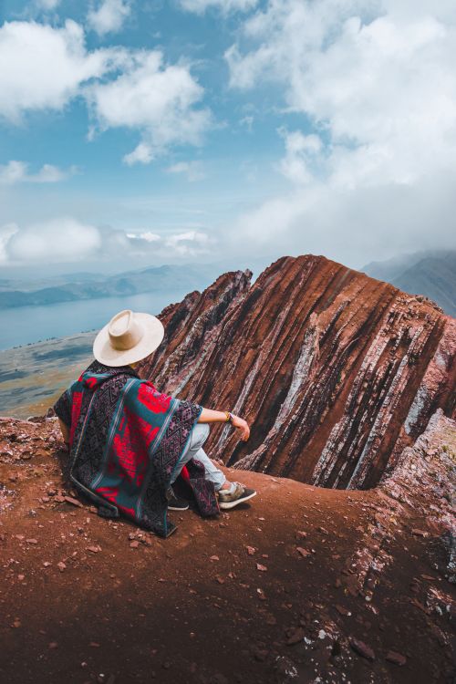 Traveler at viewpoint on the Rainbow Mountain tour