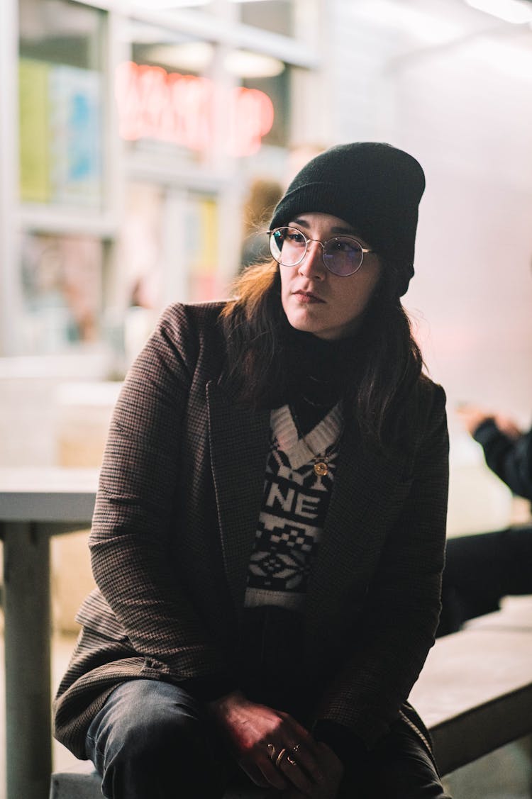 Woman Wearing Beanie Hat Sitting In Store