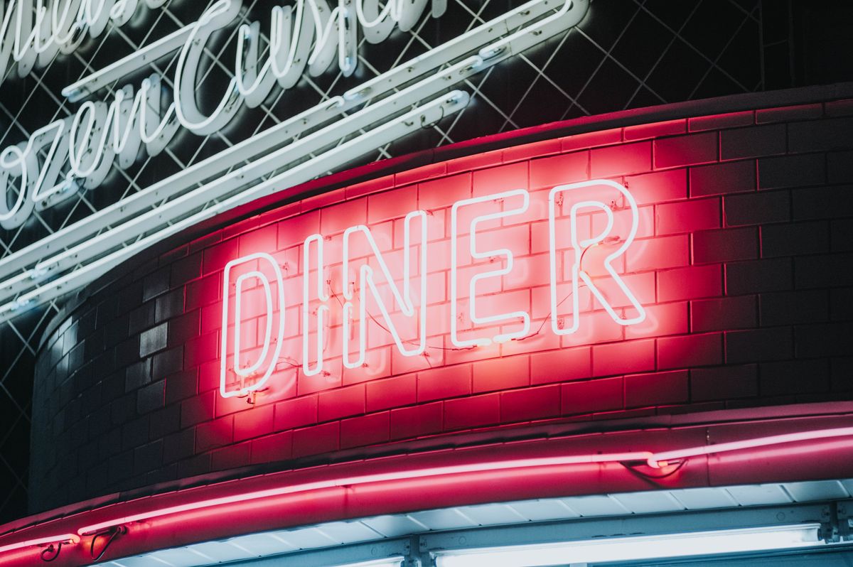 Vintage diner neon signage glowing warmly