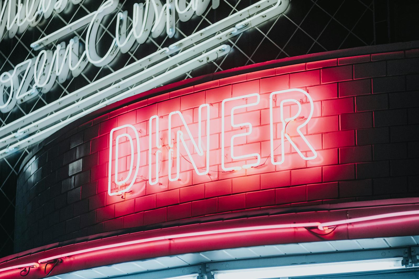 Neon diner signage at night suggesting 90s disposable nightlife