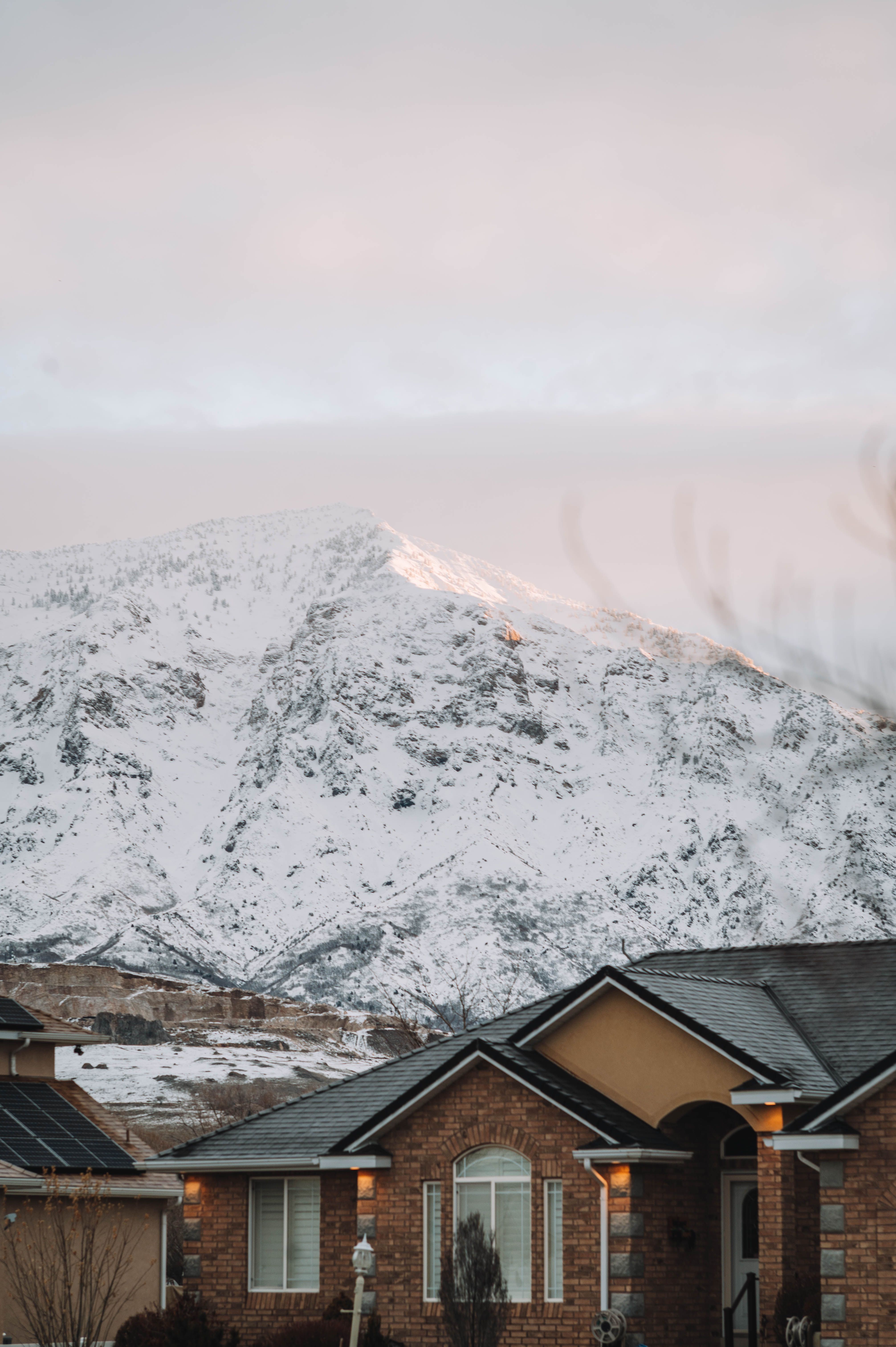 Suburban Colorado homes against a snowy mountain backdrop