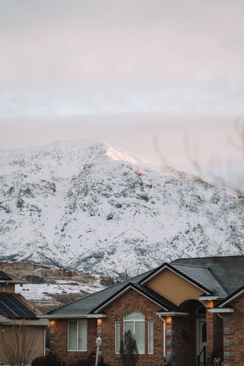 Suburban homes below snow-covered foothills