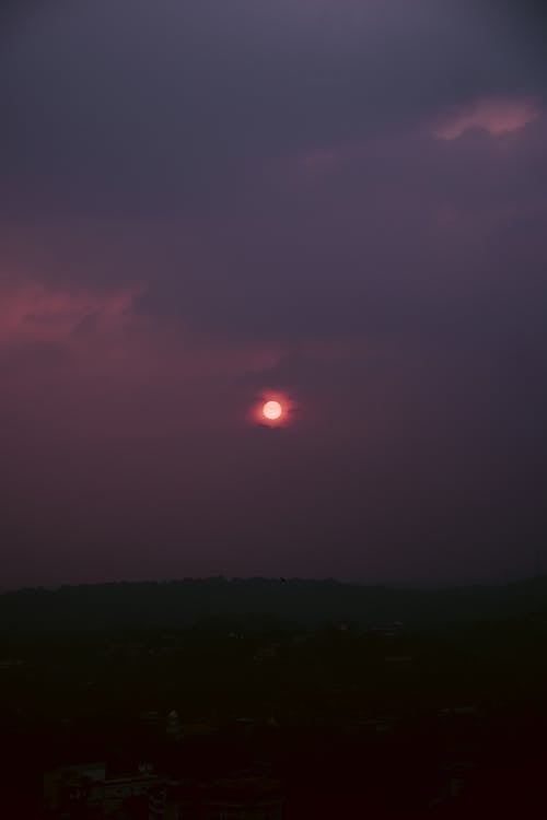 Cloudy Sky at Sunset over a Field 