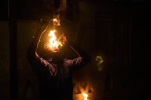 Fire-Eater Performing at Night