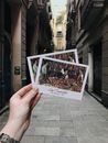 Photo of a Person Holding Postcards