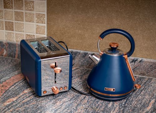 Free Stylish blue kettle and toaster set on a granite kitchen counter, adding a modern touch. Stock Photo