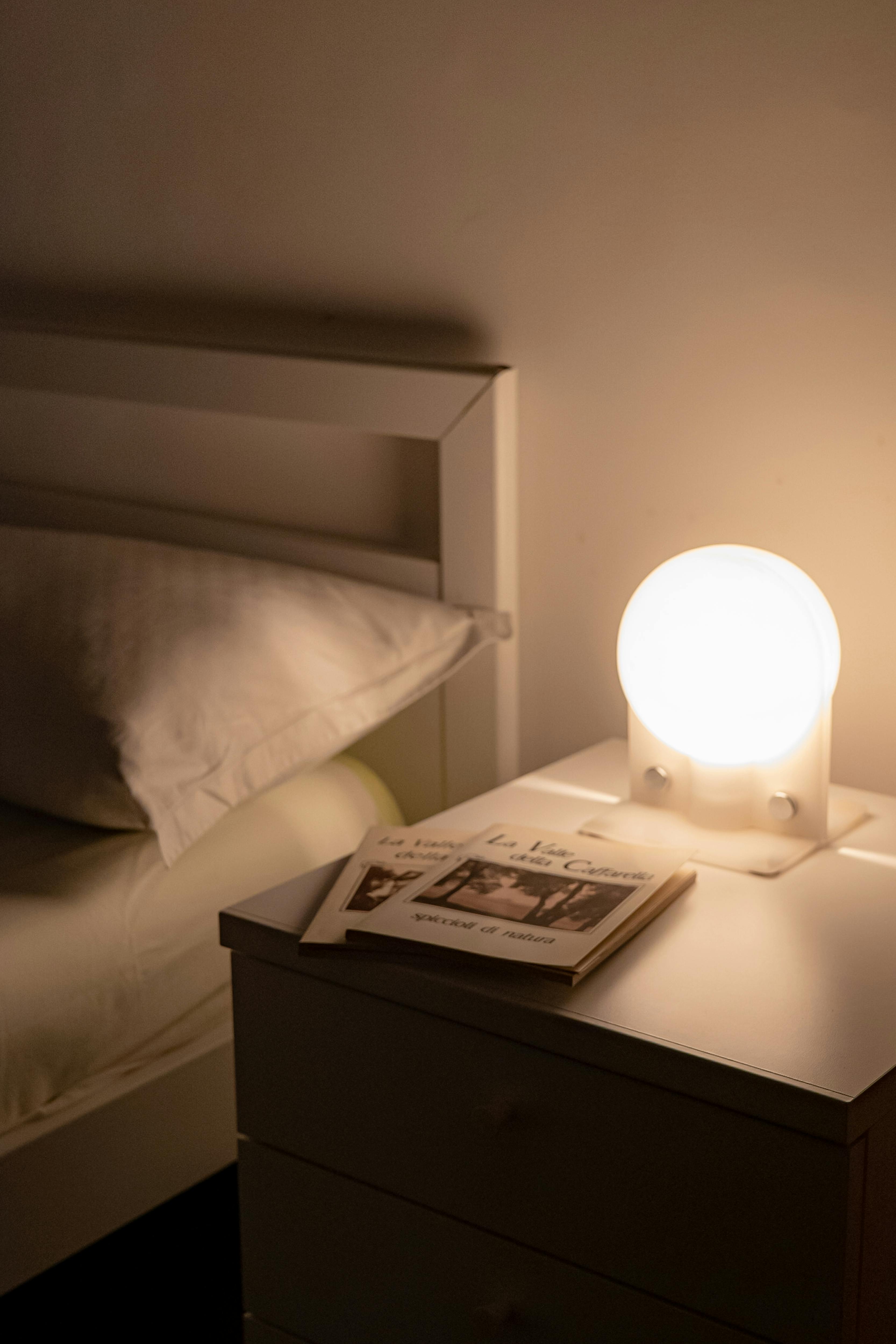 Calming bedside lamp and books for better sleep