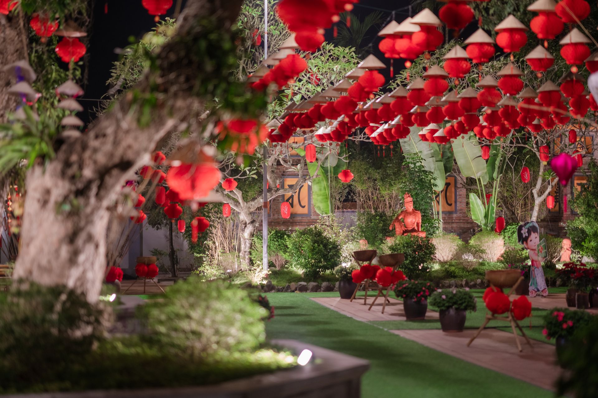 Stunning garden decorated with vibrant red Chinese lanterns at night, creating a festive atmosphere.