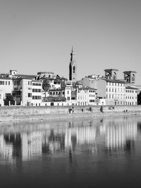 Stunning black and white cityscape of Florence, featuring iconic architecture and river reflections.