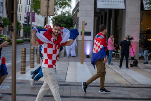 Free Men Walking with Flags of Croatia in Doha Stock Photo