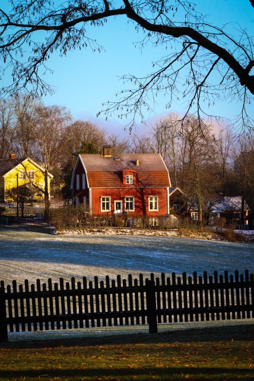 Free Beautiful winter landscape featuring a traditional village house framed by frost. Stock Photo