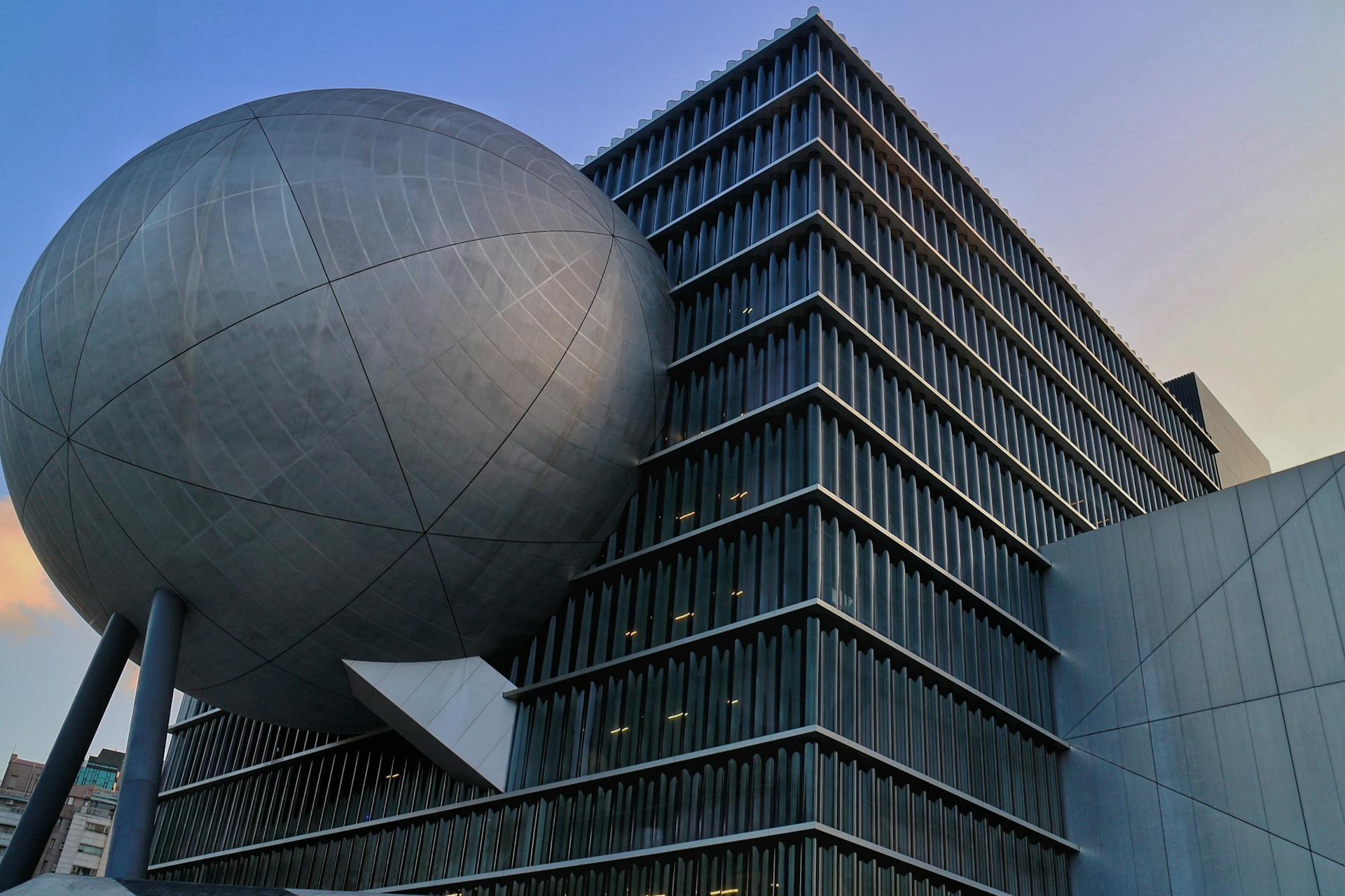 Stunning view of Taipei Performing Arts Center with its unique postmodern architecture captured at dusk.