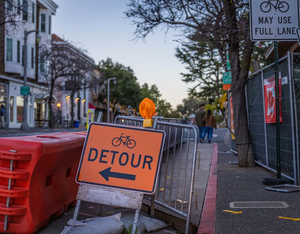 Redirection Sign Construction Directional Sign on a Sidewalk · Free Stock Photo