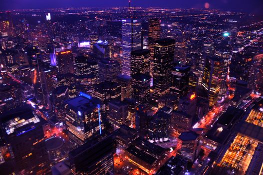 Stunning aerial view of Toronto's skyline illuminated at night, showcasing modern architecture and vibrant city lights.