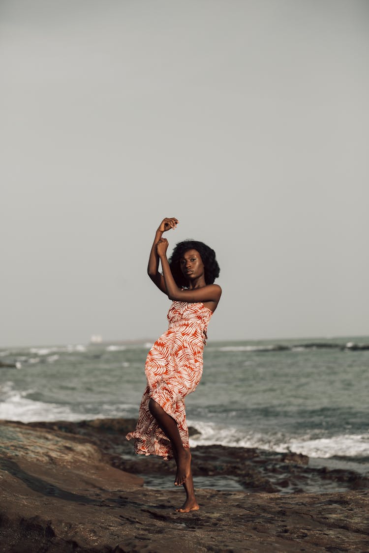 Beautiful Woman Standing On One Leg By The Sea