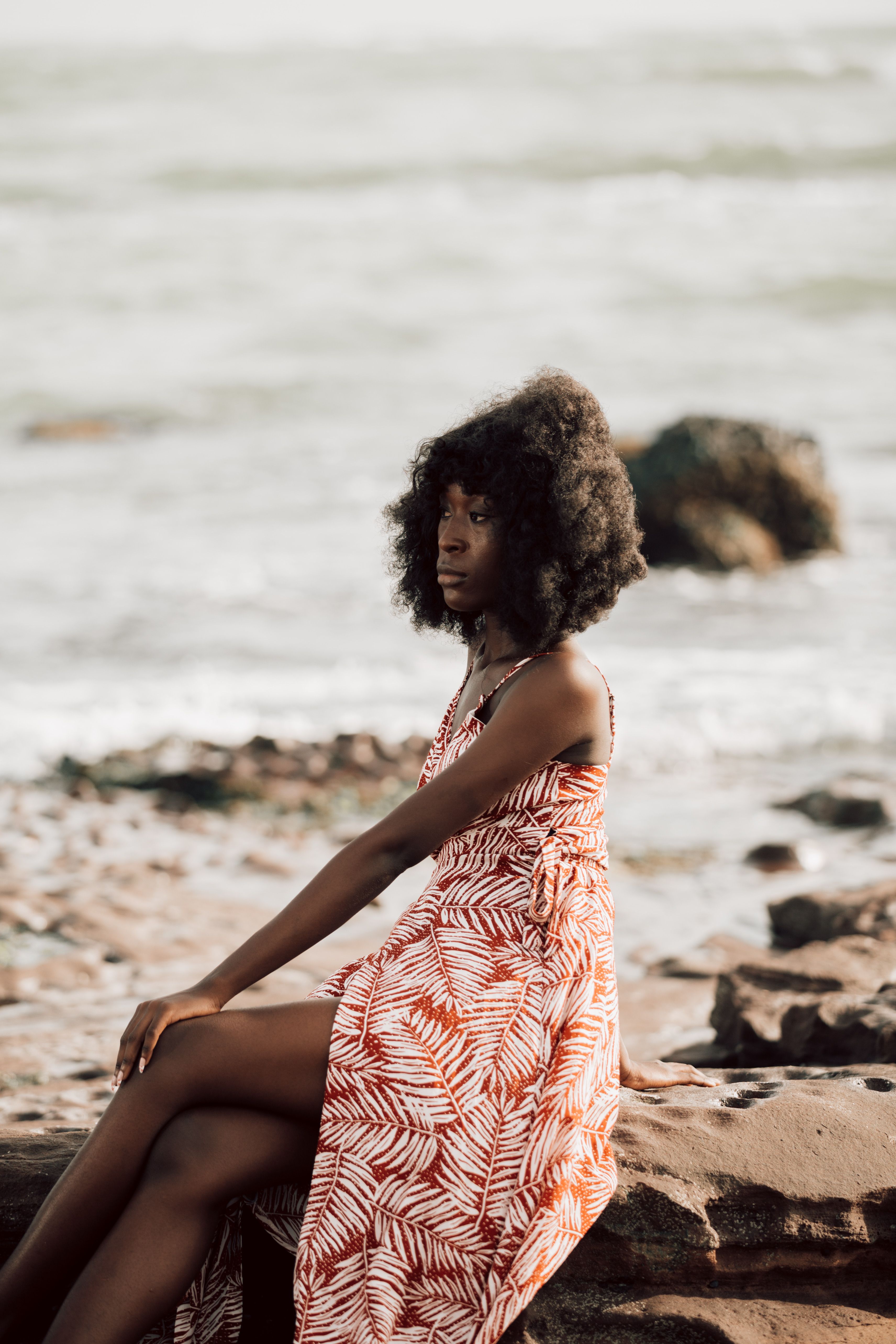 A Woman in a Dress Sitting at the Beach · Free Stock Photo